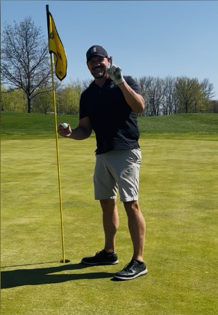 Standing by the flag on the green