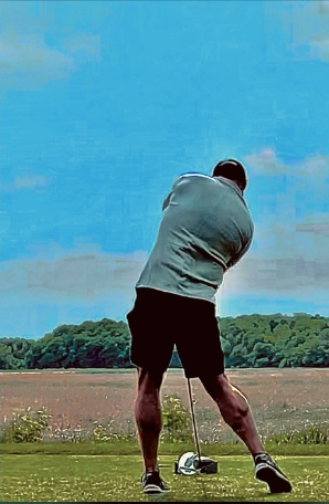 Golfer taking a full golf swing